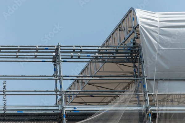 Fototapeta Scaffolding on the roof of a construction site to protect workers from the sun's rays and heat, Rome, Italy.