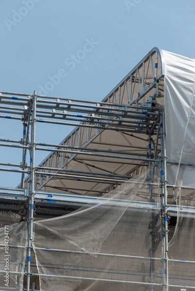 Fototapeta Scaffolding on the roof of a construction site to protect workers from the sun's rays and heat, Rome, Italy.