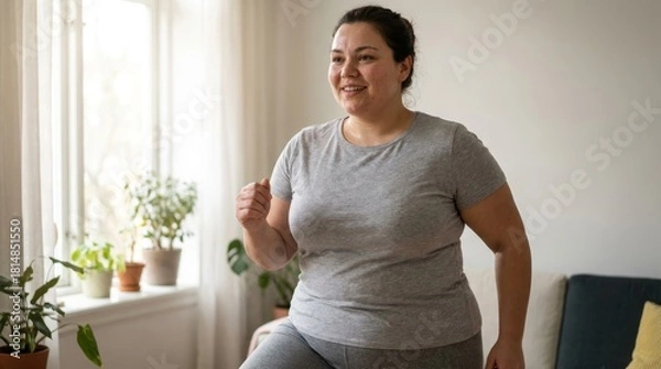 Fototapeta A Woman Exercising at Home for Health and Fitness.