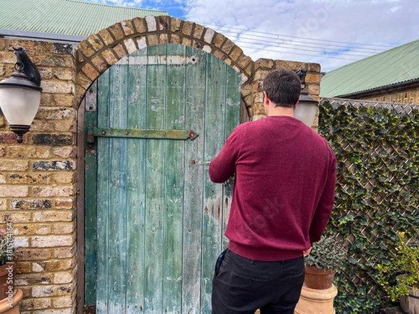 Fototapeta Man Locking Garden Gate