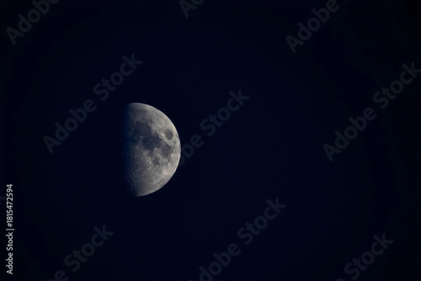 Fototapeta Detailed First Quarter Moon Phase with Visible Craters in Dark Night Sky