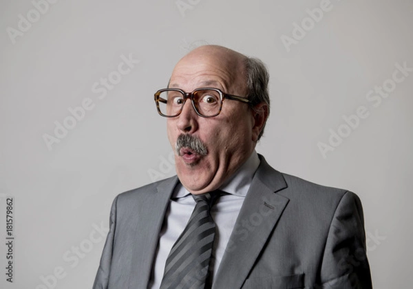 Obraz portrait of 60s bald senior happy business man gesturing funny and comic in laughter and fun face expression looking happy