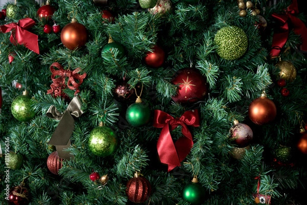 Fototapeta decorated with baubles Christmas tree. part. background