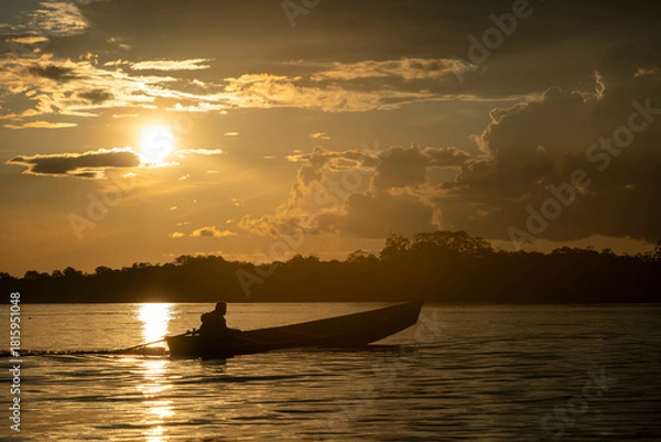 Fototapeta wooden boat in amazon river at sunset