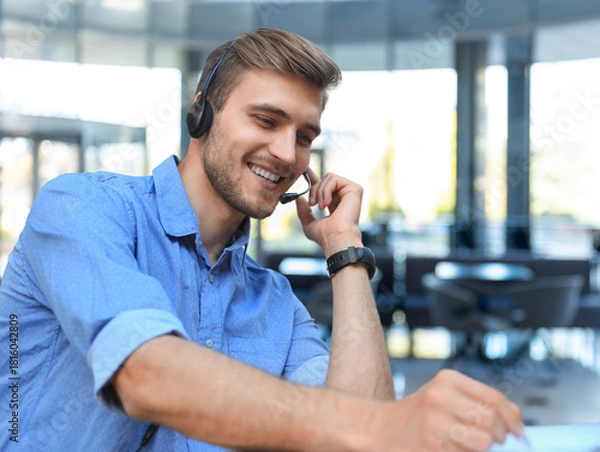 Obraz Smiling friendly handsome young male call centre operator