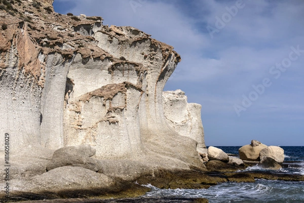 Fototapeta Eroded volcanic rock formations on the coast of Cabo de Gata. Cala de Enmedio beach and cliffs.