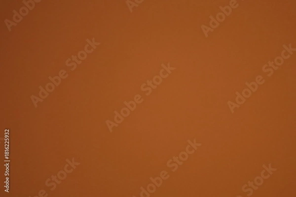 Obraz A soft, abstract, and moody background texture with a gentle, out-of-focus red and orange light leak on a brown backdrop.