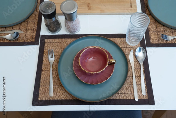 Obraz Elegant table setup with a vintage teacup adding warmth and charm to a serene dining atmosphere.