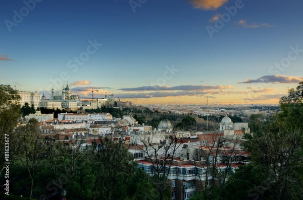 Fototapeta Panoramic view of Madrid cityscape with the Royal Palace and Cathedral de la Almudena at the left side taken from Debod's temple at sunset. HDR image.