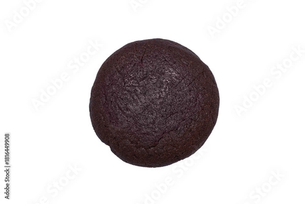 Fototapeta A top-down close-up of a single round, deep dark brown or black cookie. The cookie has a rough texture and is isolated on a pure white background