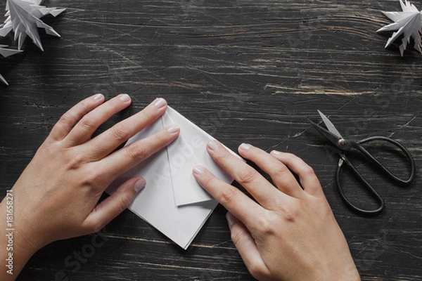 Obraz Hands making origami Christmas tree