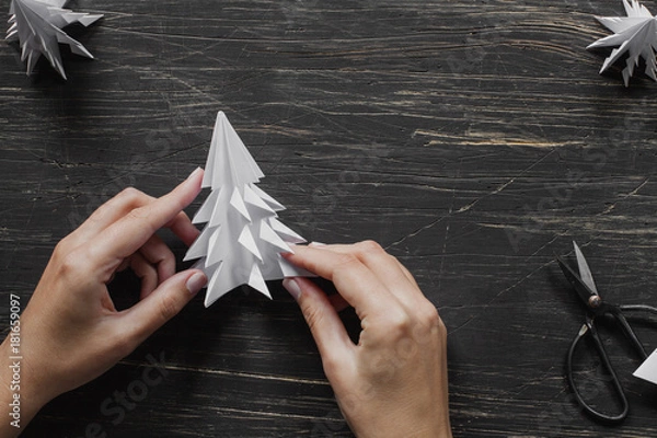 Obraz Hands making paper Christmas tree