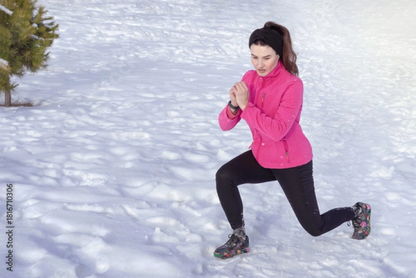 Obraz Caucasian woman does sport in the snow in winter. Winter sports, activity. Lunge exercises on snow