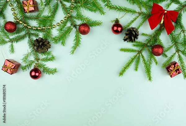 Fototapeta  Christmas tree branches with  cones, red balls and small presents, copy space