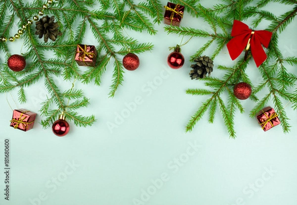 Fototapeta  Christmas tree branches with  cones, red balls and small presents, copy space