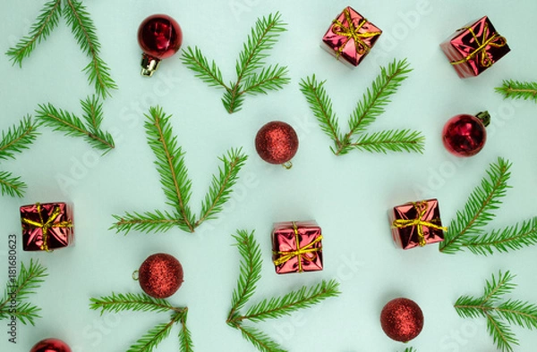 Fototapeta Christmas New Year pattern ornament with green branches, cones, red balls and small presents on mint background