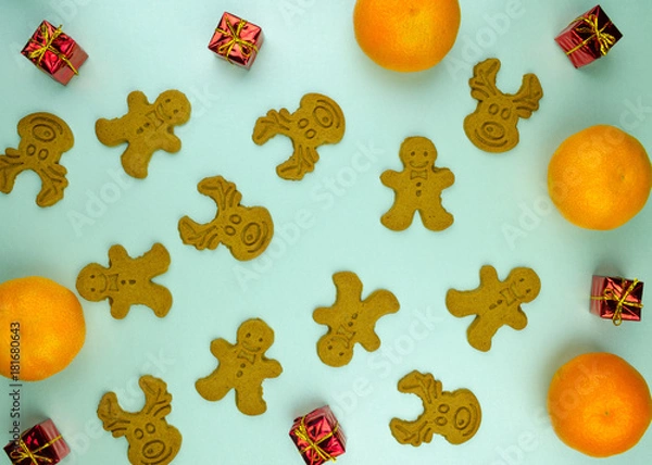 Fototapeta Christmas New Year pattern ornament with cookies, green branches and red small presents balls on mint background