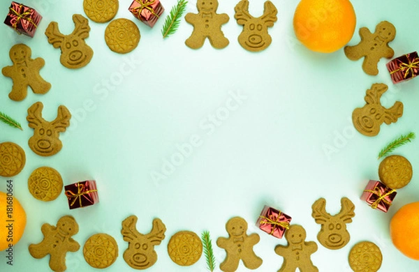 Fototapeta Christmas New Year pattern ornament with cookies, mandarins and red small presents on mint background