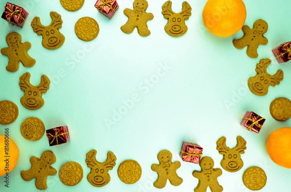 Fototapeta Christmas New Year pattern ornament with cookies, mandarins and red small presents on mint background