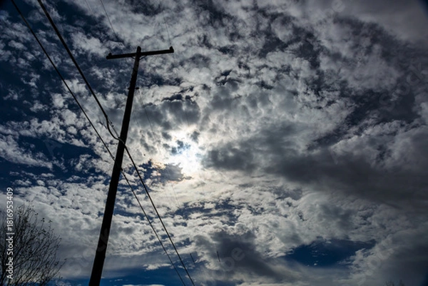 Obraz dynamic image of power lines with telephone pole against a moonlit cloudy sky at night