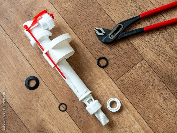 Fototapeta Toilet cistern repair. Flush box inlet valve   with bottom connection. Intake mechanism with lower connection 