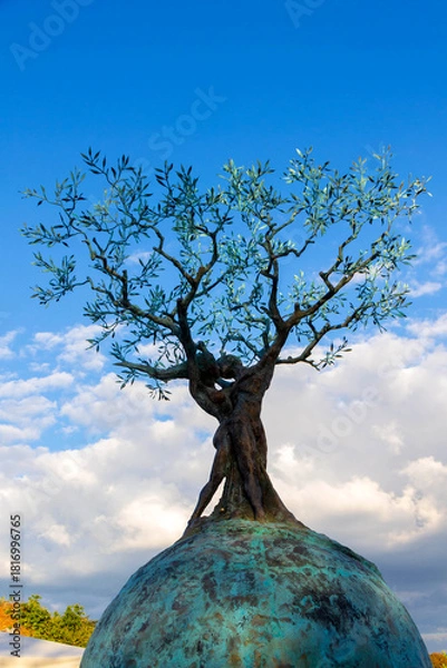 Obraz Olive Tree Sculpture Rises From a Round Earth Base Under a Bright Blue Sky