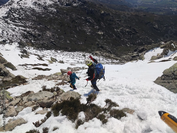 Obraz Man with his son walking across snowy terrain