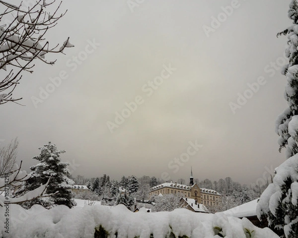 Fototapeta Winter landscape with first snow covering trees and historical building in Chartreuse mountains France