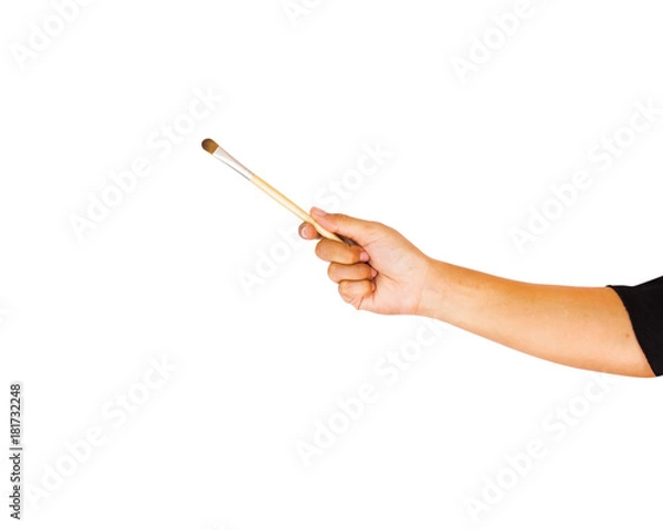 Fototapeta Hand holding eye shadow brush isolated on white background with clipping path. Eye shadow is a cosmetic that is applied on the eyelids and under the eyebrows.