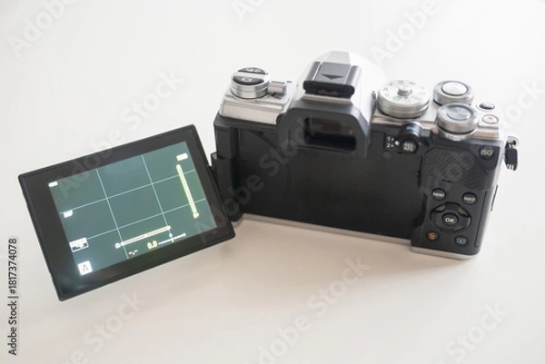 Fototapeta Modern digital camera with a vintage look, seen from the back with the tilting screen unfolded