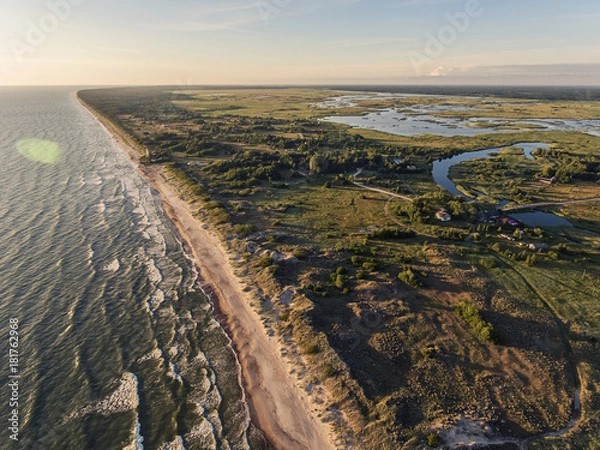 Fototapeta Aerial view over a Baltic Sea shore line in Pape, Latvia. During summer season.