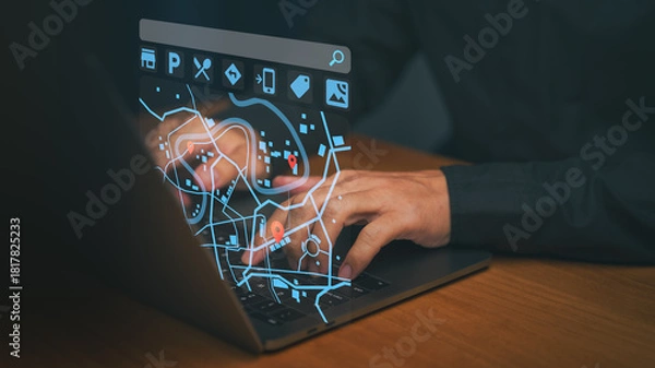 Fototapeta Man using a laptop computer with a futuristic digital map interface showing a red location pin, representing online navigation, GPS tracking, digital maps, and real-time geolocation technology.