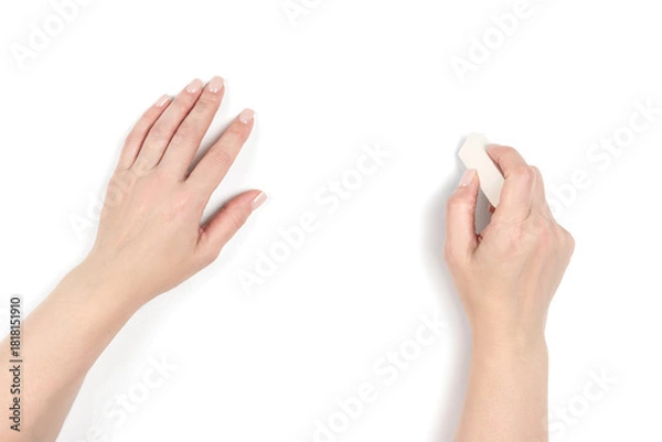 Obraz Top view of a woman's hands on transparent background, one holding a eraser. Creative concept. Hand close-up, ready to correct or draw. 