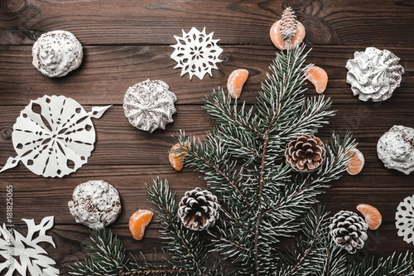 Fototapeta Brown wood background. Slice of mandarins. Fir tree and cones. Sweets. Christmas and New Year decorations. Xmas and Happy New Year composition. Flat lay, top view