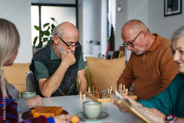 Fototapeta Group of senior people enjoying different activities together in a community center