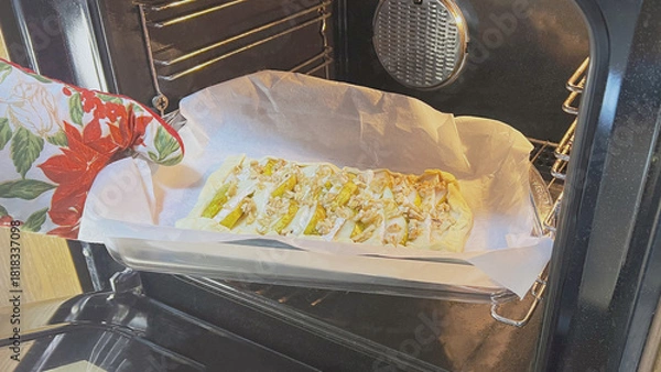 Fototapeta Tofu being baked in an oven with seasoning on parchment