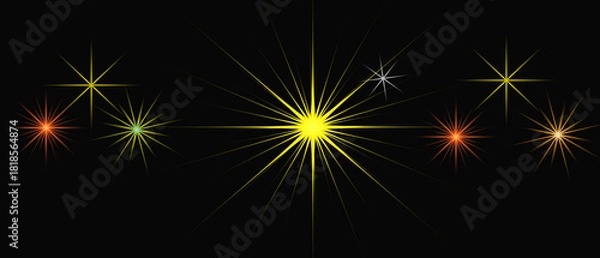 Fototapeta A collection of brightly colored starbursts and sparkling light effects on a black background