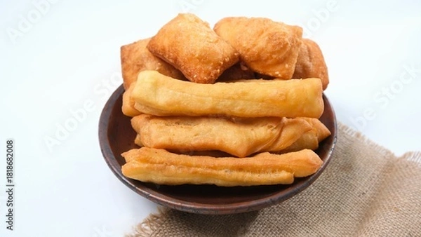 Fototapeta Golden Fried Dough Sticks and Squares on Plate