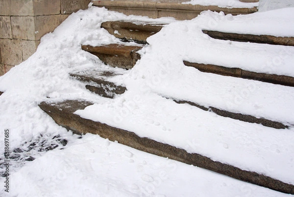 Obraz A well-trodden path on steps that have not been cleared of snow and ice. Health hazard concept of slippery stairs and steps.