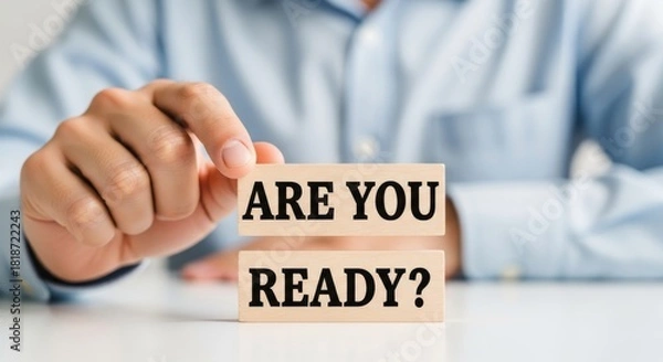 Obraz Readiness Concept: A person holds wooden blocks inscribed with the phrase ARE YOU READY?, a visual metaphor for preparedness, anticipation, and proactive initiative.