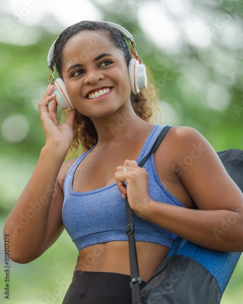 Fototapeta Woman standing outdoors with arms open wide, deep breath, personal freedom, stress relief, and mental wellness in nature