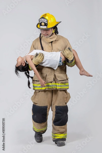 Fototapeta Isolated firefighter rescues child from danger