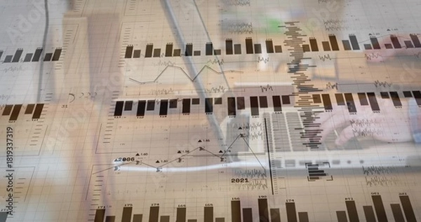 Obraz Analyzing hands wearing light-sleeved writing on paper at office desk, with pen, laptop and charts