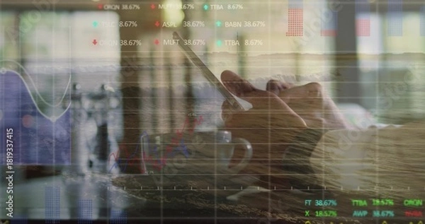 Obraz Tapping man wearing shirt holding smartphone at cafe, with coffee mug and stock charts