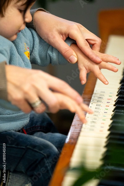 Fototapeta Gentle guidance musical moments little hands learn piano under watchful eyes learning to play together in a nurturing embrace of music and shared discovery at home during the daytime
