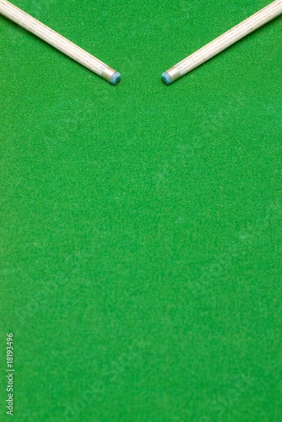 Obraz Ends of two pool cue sticks against green baize texture
