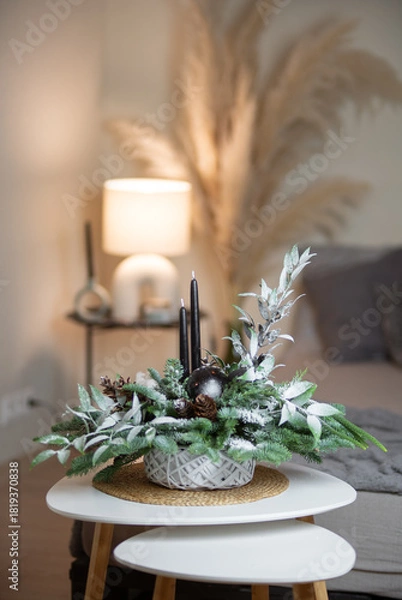 Fototapeta Winter Holiday Centerpiece With Pine Branches, Candles and Natural Decor