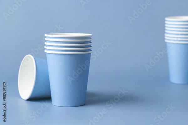 Fototapeta Disposable light blue paper cups closeup, mockup, copy space. No plastic biodegradable single-use