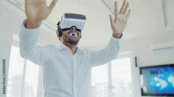 Obraz Man Wearing Virtual Reality Headset Smiling Joyfully in Bright Modern Office