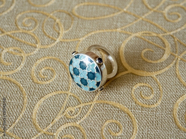 Fototapeta Silver ring with hot enamels. Jewelry design ideas. A large, beautiful ring with an expressive pattern